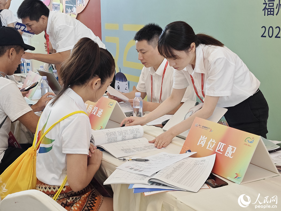 8月10日，“好年華·聚福州”2023年閩臺(tái)青年人才研學(xué)營(yíng)招聘會(huì)現(xiàn)場(chǎng)，一位臺(tái)灣青年正在工作人員的協(xié)助下挑選適合自己的崗位。人民網(wǎng) 黃東儀攝