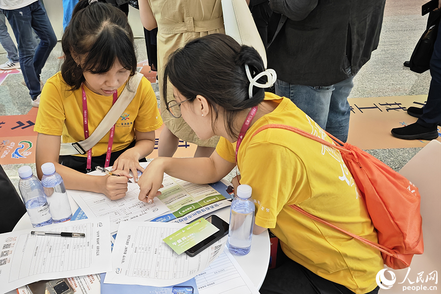 8月10日，“好年華·聚福州”2023年閩臺(tái)青年人才研學(xué)營(yíng)招聘會(huì)現(xiàn)場(chǎng)，兩位臺(tái)灣青年正填寫(xiě)求職材料。人民網(wǎng) 黃東儀攝