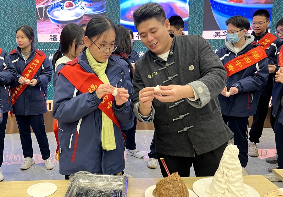 2019年，元宵丸制作技藝（耳聾伯）被列入福建省第六批非物質(zhì)文化遺產(chǎn)代表性項(xiàng)目名錄。圖為耳聾伯元宵的第四代傳承人林威教孩子們包元宵。陳錦攝