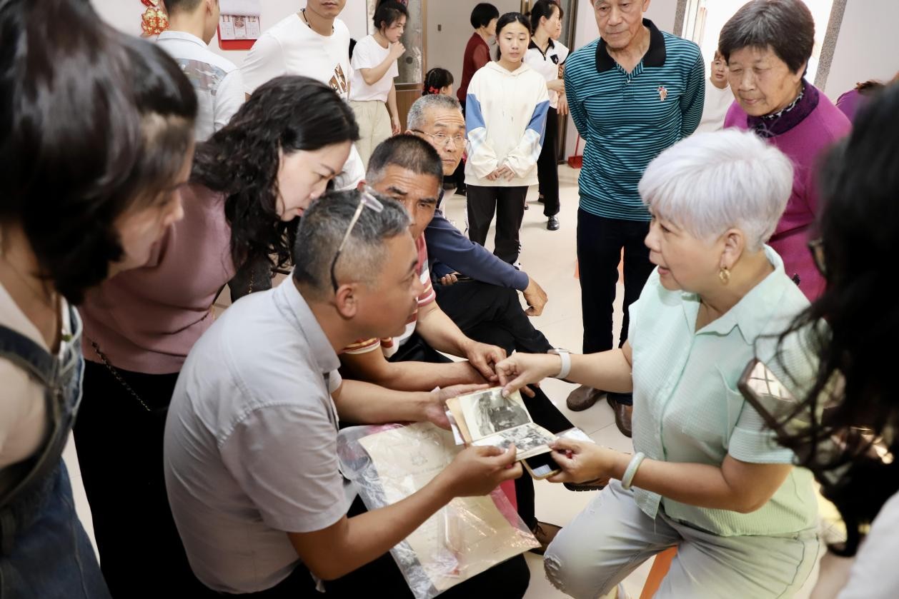 來自馬來西亞吉隆坡閩籍華人葉秀琴三姐妹及親屬在同安區(qū)僑聯(lián)協(xié)助下返鄉(xiāng)尋根，回到故鄉(xiāng)漳州市角美鎮(zhèn)金山村充龍社。圖為同安區(qū)華僑歷史學(xué)會會長莊志鵬與葉秀琴女士翻看老相冊。同安區(qū)僑聯(lián)供圖
