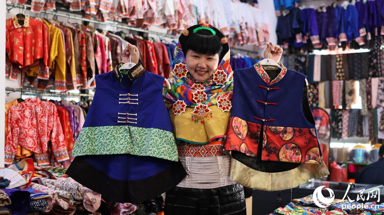 惠安女服飾非物質(zhì)文化遺產(chǎn)傳承人曾茹婷展示改良前后的“貼背”。人民網(wǎng) 李昌乾攝