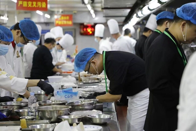 參賽隊(duì)員正在認(rèn)真制作菜肴