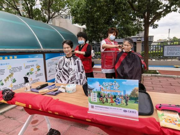 工作人員為社區(qū)老年居民提供免費(fèi)理發(fā)服務(wù)
